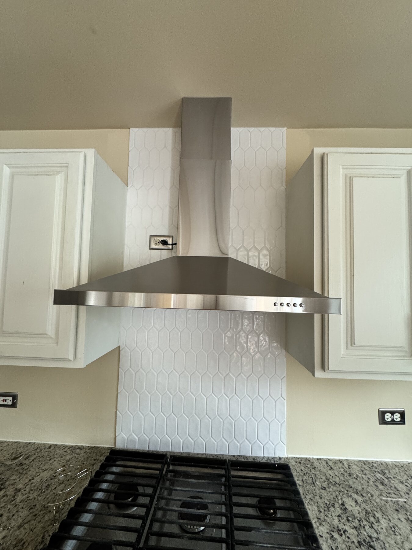 Installed kitchen backsplash and range hood