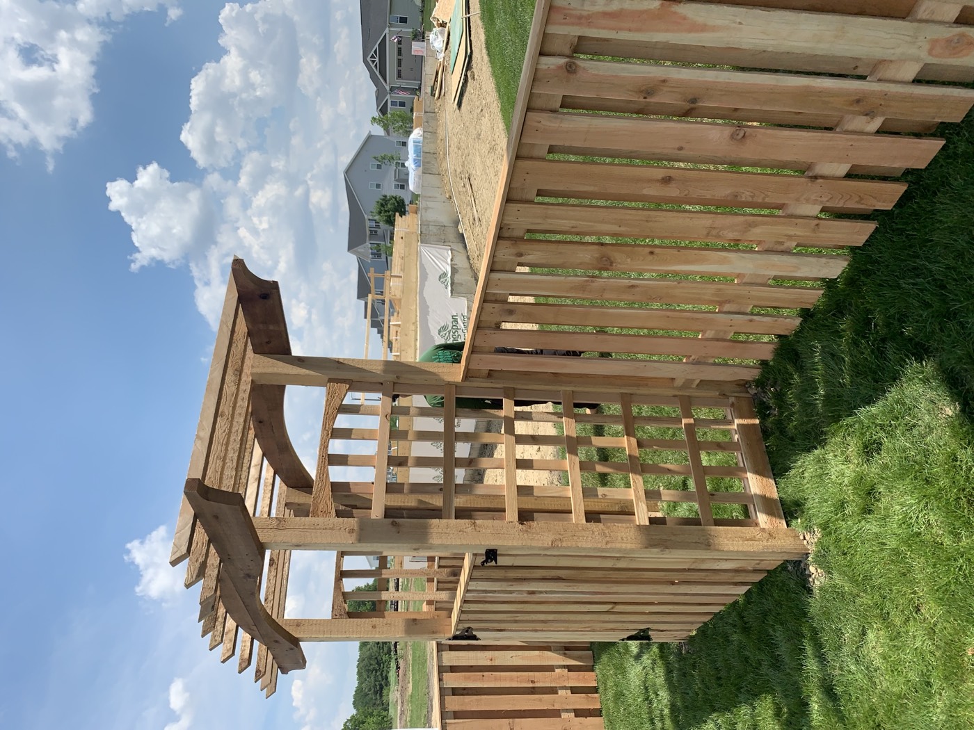 Completed custom wood fence with a decorative arbor gate